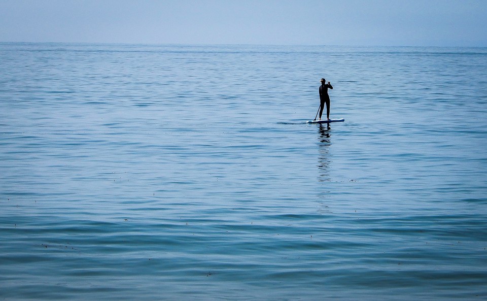 a_photo_of_a_single_paddle_surfer